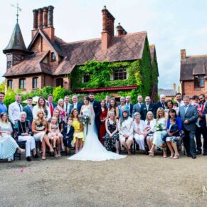 Large family wedding group pose captured on a summer's day at The Five Arrows Hotel in Waddesdon 
