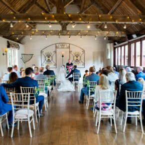 The civil ceremony in progress in the former stables on a lovely summer's day