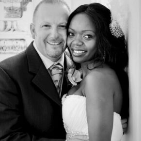 Black and white portrait photography of the happy newlyweds in the grand entrance area of the White House at their Beaumont Estate wedding