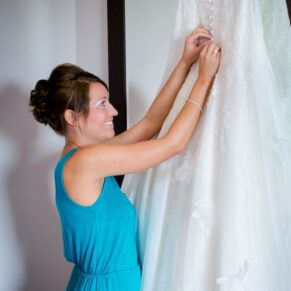 Wokefield Estate Berkshire Wedding Photography - the bride checks over her gown on a hanger