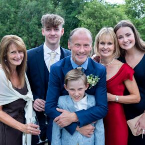 A relaxed group pose of the newlyweds with their children & relatives taken in the lovely gardens of Saint Michael's Manor