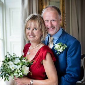 A romantic window lit portrait of the newlyweds inside Saint Michael's Manor