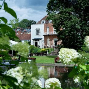 The historic Saint Michael's Manor viewed through the gorgeous flower gardens