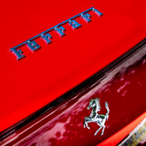 Close-up of the groom’s Ferrari at this woodland marriage