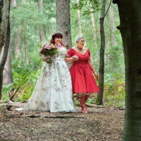 This candid photograph was captured as the bride and mum approached the woodland ceremony area
