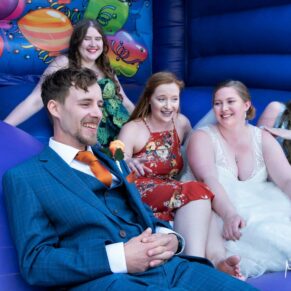 Candid wedding moment in the bouncy castles at The Mercure Lambert Hotel, Thame