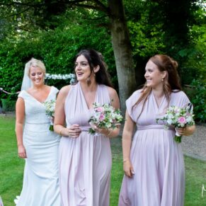 The bridesmaids take a stroll in the gardens, captured at The Grange, Northwood 
