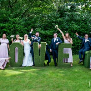 A fun group pose captured at The Grange, Northwood wedding