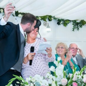 The groom kisses his mum during his wedding speech, captured at The Grange, Northwood 