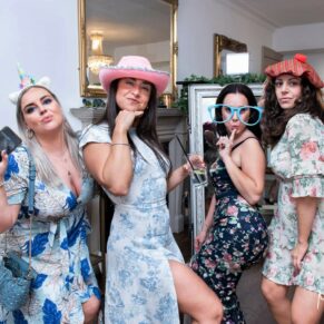 A fun shot captured of four wedding guests posing for the camera at The Grange, Northwood 