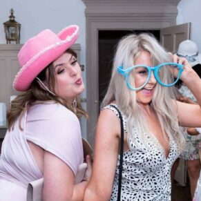 Two ladies in their photo-booth outfits, captured at The Grange, Northwood wedding 