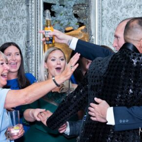 Joyful hugs from the wedding guests captured at The Grange, Northwood 
