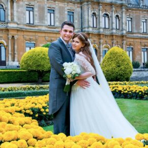 Bride & groom pose in the flower borders at Waddesdon Manor 