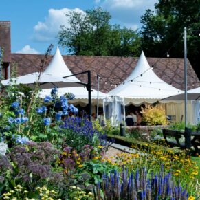 The Five Arrows Hotel wedding marquee and former stables captured under near perfect blue skies 