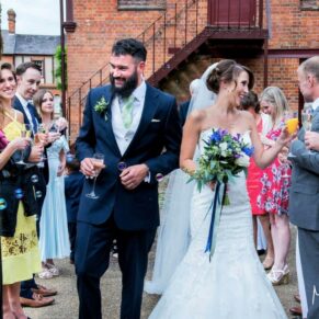 Reception confetti aisle captured soon after the end of the civil ceremony - with lovely smiles from the newlyweds and the guests