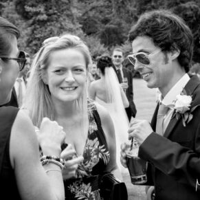 Reportage capture of some lively guests during the wedding drinks reception at Danesfield House Hotel 
