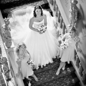 The bride on the Jacobean staircase with her bridesmaids captured from above at Hartwell House 