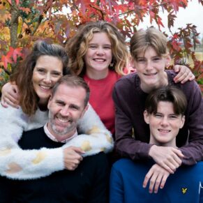 Relaxed family portrait of five captured in a Chilterns woodland setting for their Buckinghamshire photo session 