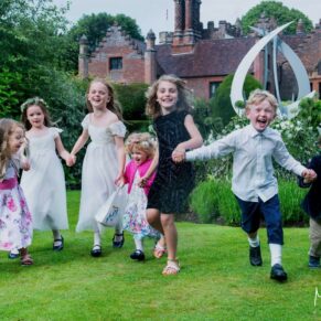 Kids always seem to dash around like crazy when there's so much to explore at Chenies Manor House during a wedding reception