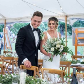 The happy bride and groom see the marquee interiors for the first time at their reception