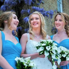 The bride and bridesmaids take a seat on the ground for a casual photography pose indoors at this lovely relaxed Beaumont Estate wedding 