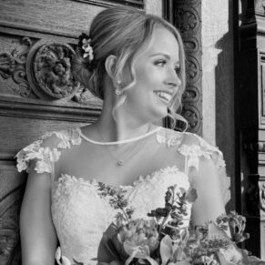 Buckinghamshire Black and White Wedding Photography - close-up bridal portrait captured at Waddesdon Manor against an ornate wooden door 