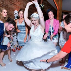 Candid and reportage Buckinghamshire wedding photographer - the bride spinning around on the dancefloor 