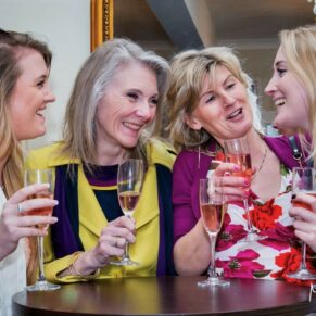 Candid moment between four ladies captured during the drinks reception indoors at the Kings Chapel in Old Amersham 