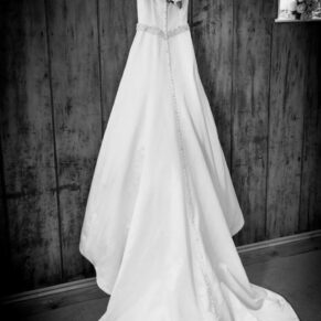 The bride's gown hanging up before her civil ceremony at her Kings Chapel wedding in Old Amersham 