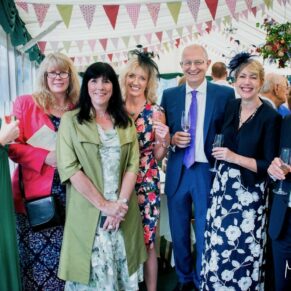 Buckinghamshire Marquee Wedding Photography - group of friends pose for the camera in this colourful interior 