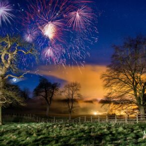 Buckinghamshire Winter Wedding Photography - fireworks illuminate the dramatic skyline above Missenden Abbey 