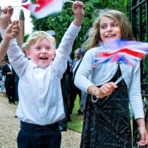 These kids just loved the moment when they were handed some flags to wave at this Chenies Manor wedding
