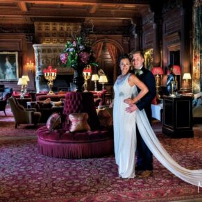 Stunning lighting and atmospheric backdrop for this photography pose of the newlyweds in the Great Hall at Cliveden House on their wedding day  