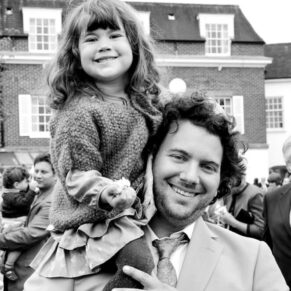 Relaxed pose of a father and daughter captured during the drinks reception