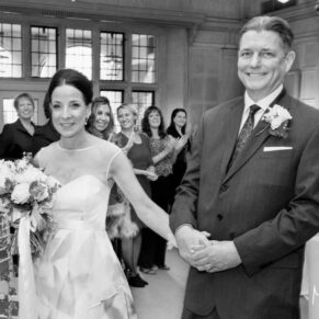 The newlyweds exit their Danesfield House wedding civil ceremony with big smiles across their faces