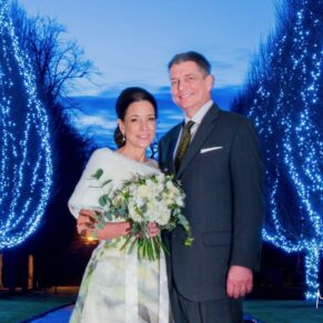 Night shot of the wedding newlyweds captured with my atmospheric floodlighting under the entrance archway at Danesfield House