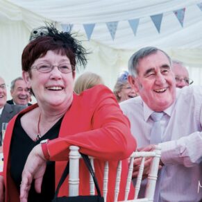 Guest reactions during the speeches at this lively Dorton House marquee wedding reception 