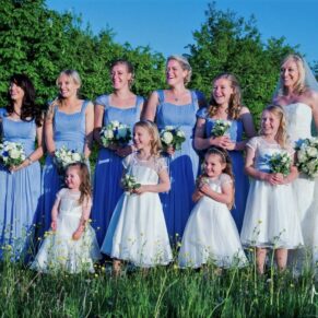 The ladies all gather for photo in the tall grass meadow at this gorgeous Dorton House summer wedding  