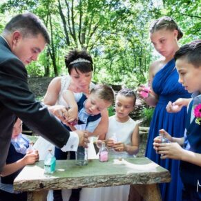A wonderful sand ceremony in progress during the celebrant led civil marriage at this woodland marriage