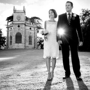 A sunlight starburst really makes this walking shot of the newlyweds as magical as can be at their Hartwell House wedding