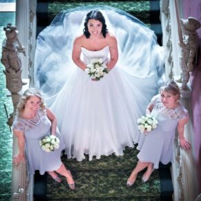 The bride with her bridesmaids captured dramatically from above on the grand staircase at Hartwell House 