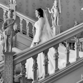 The bride makes her way down the Jacobean staircase on her wedding day at Hartwell House Hotel 
