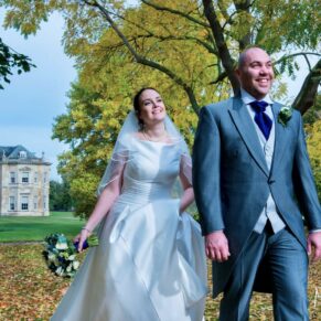 The newlyweds taking a stroll through the autumnal gardens at Hartwell House Hotels