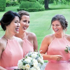 Three bridesmaids enjoying a giggle during the drinks reception at this Hartwell House summer wedding 