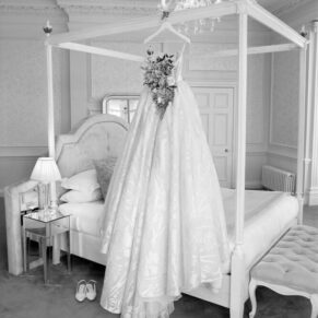 The bridal suite with the gown hanging from the four poster bed at this grand Buckinghamshire venue