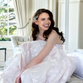 The bride captured adjusting her shoes before her ceremony in the grand bridal suite at her Hedsor House wedding  
