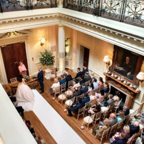 The wedding ceremony in progress from high above on the balcony in the gorgeous Great Hall at Hedsor House