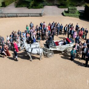 Big wedding group pose of everyone captured from above at the front of Hedsor House  