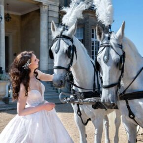 The bride with the horses after the ceremony at her Hedsor House wedding reception