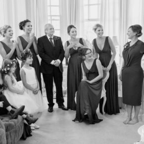 Dad and the bridesmaids get to see the bride's dress for the first time as she makes her grand entrance into the bridal suite